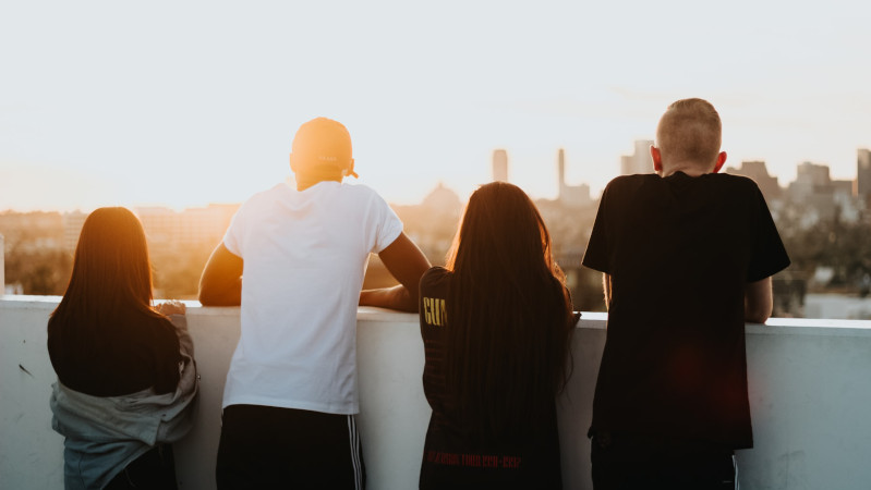 Four young people looking across a city skyline