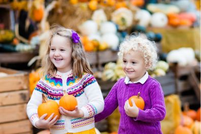 children carrying pumpkins