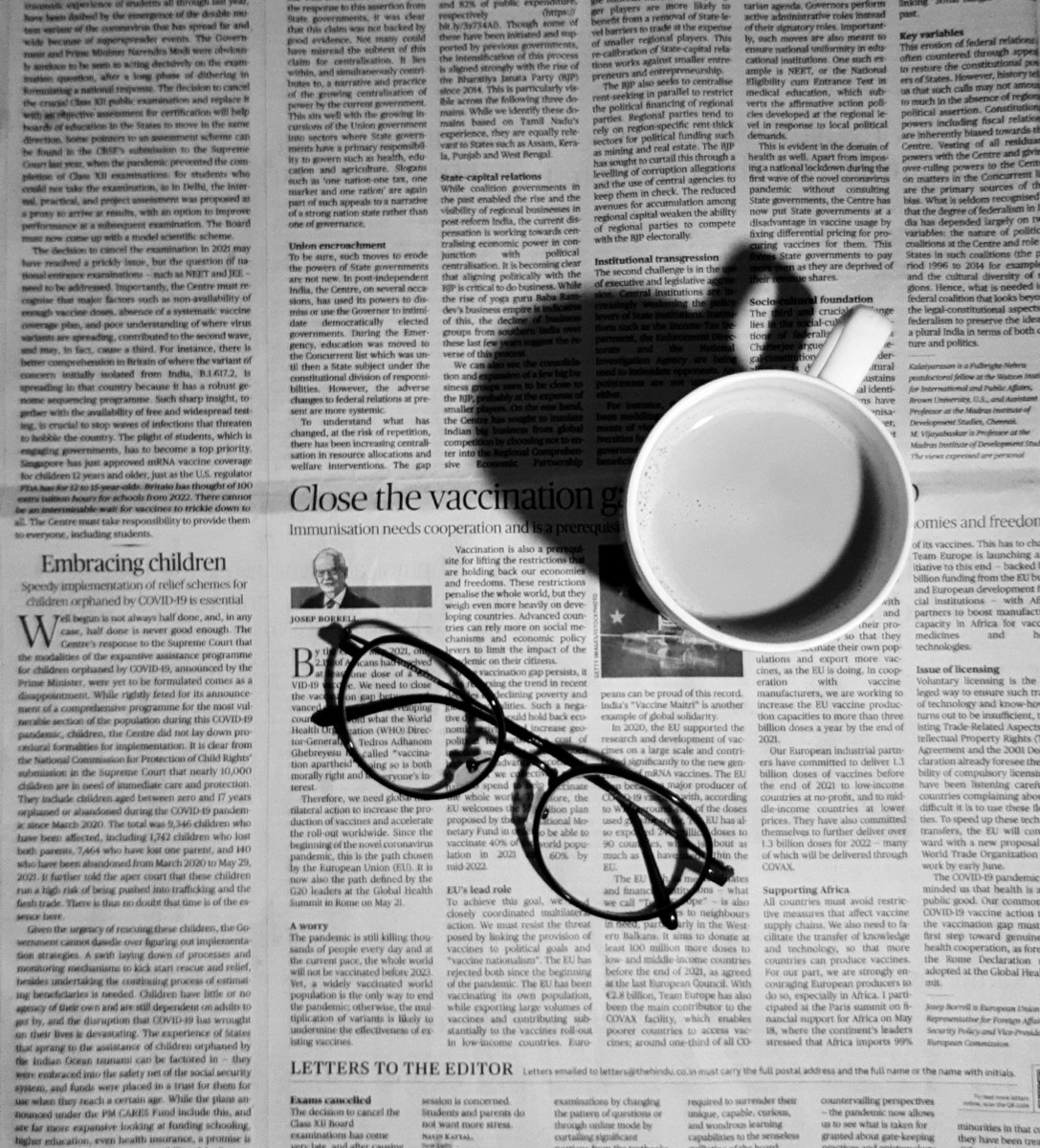 folded glasses on newspaper