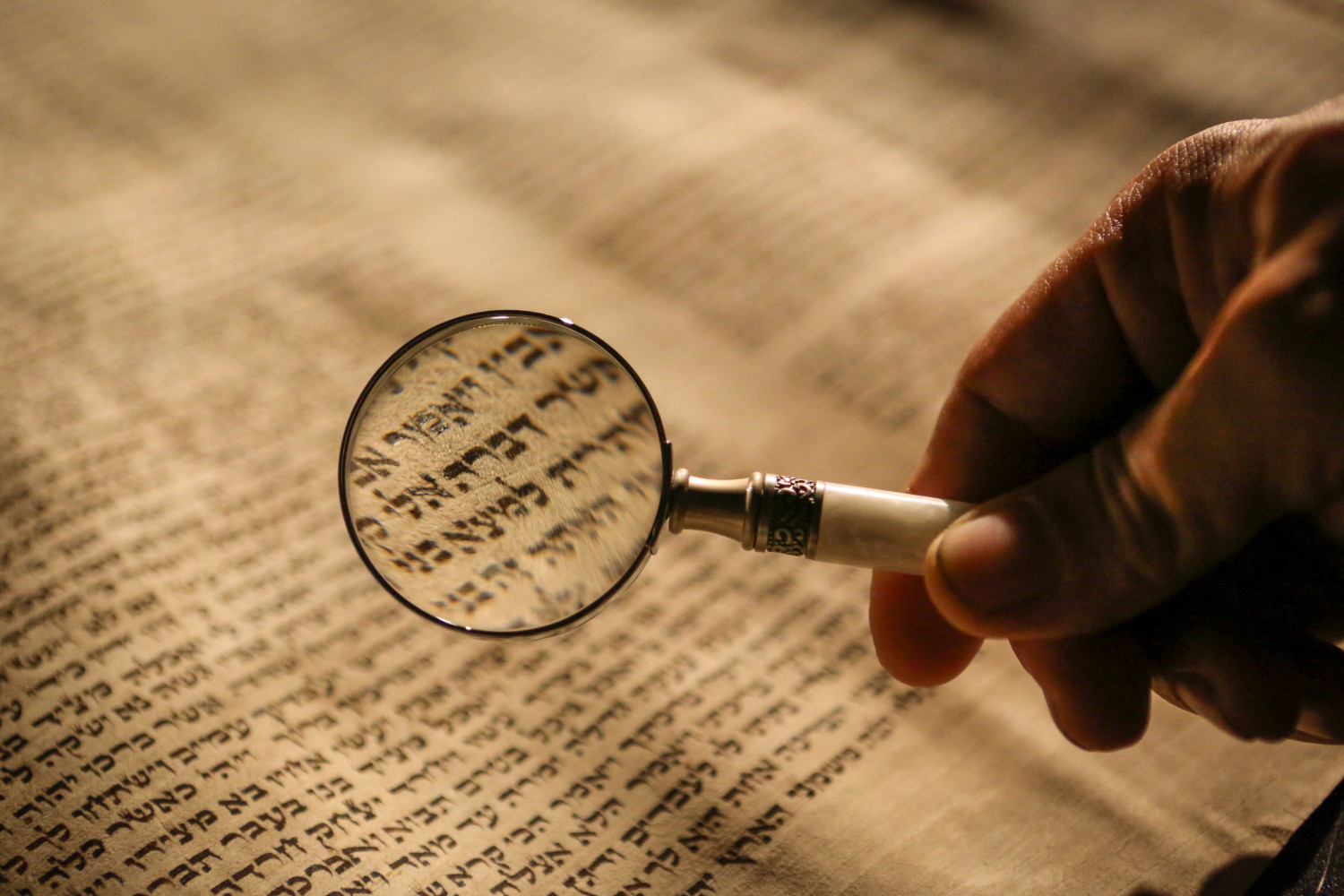 Magnifying glass on Hebrew text
