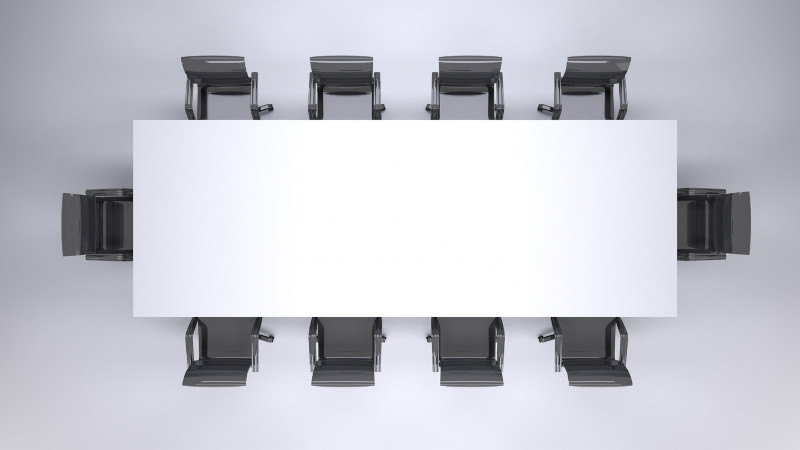 A board room table with chairs around