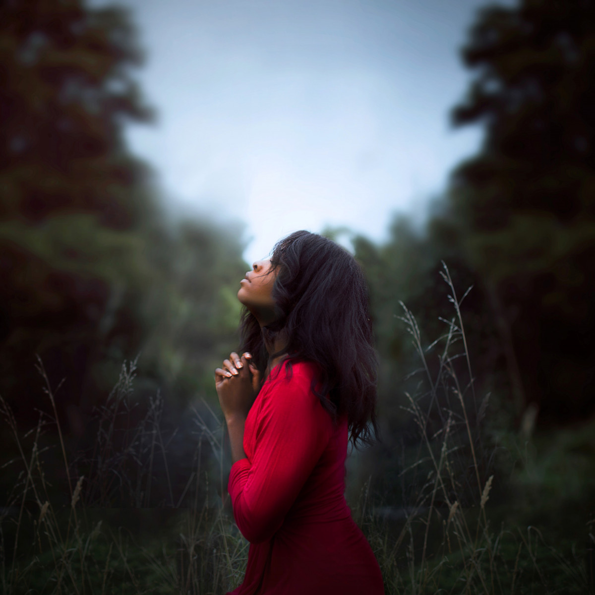 Person praying in a field
