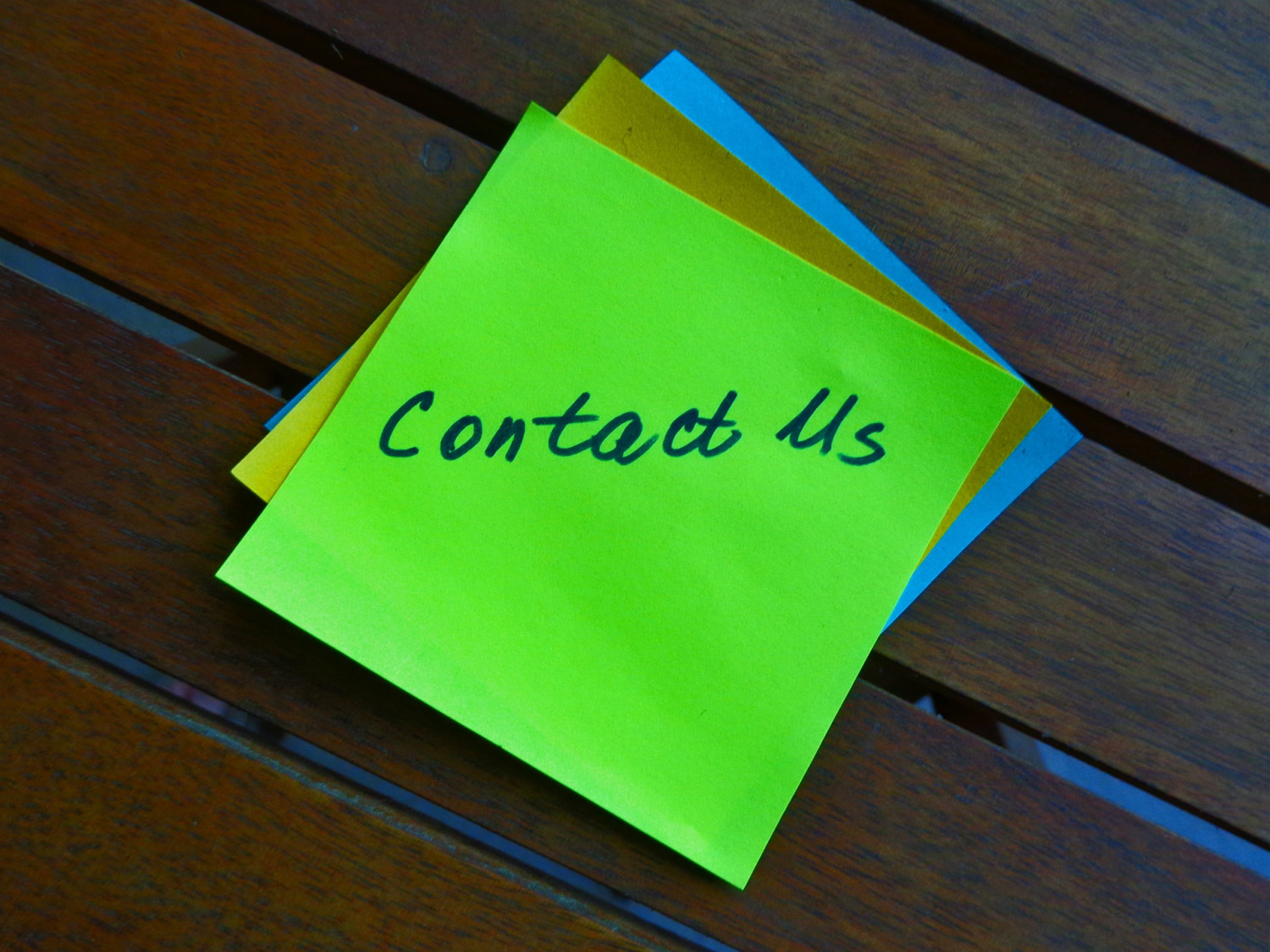 Post it note with 'contact us' written on